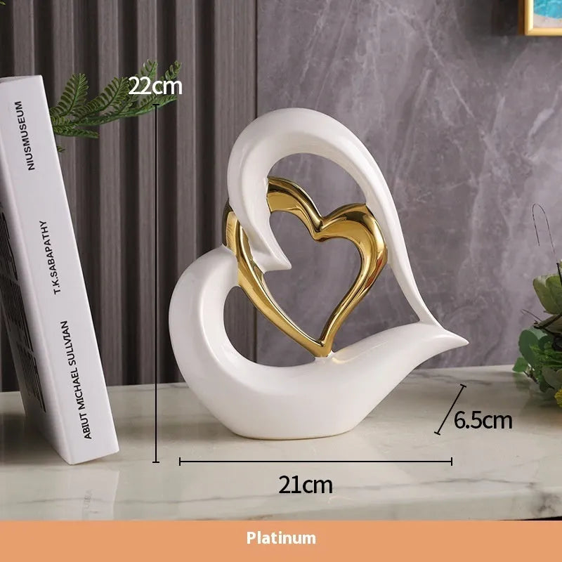 Modern geometric love heart ornament in white porcelain with metallic finish on display surface