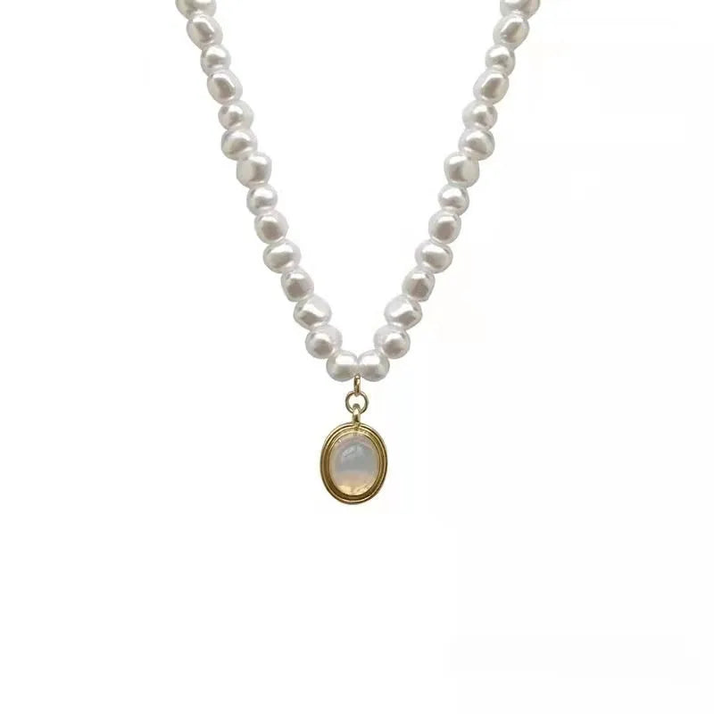 Geometric French Court vintage pearl necklace with adjustable chain on a dark background.