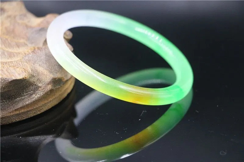 Women's jade bracelet with floating flower design in ice-like emerald appearance