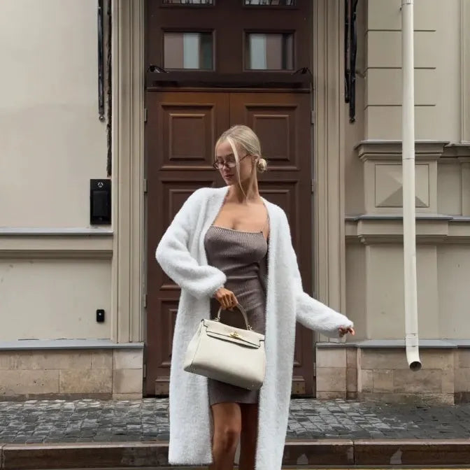 Long white women's cardigan jacket with loose fit and long sleeves.