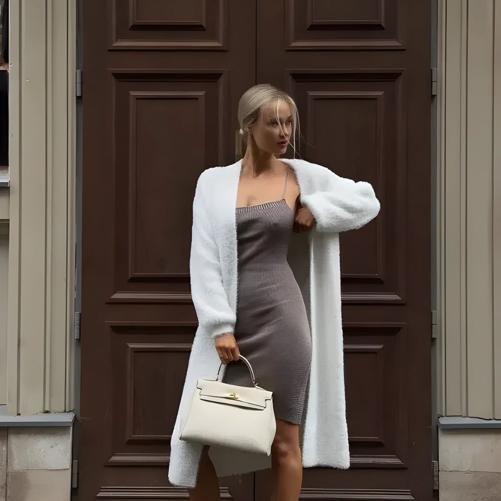 Long white women's cardigan jacket with loose fit and long sleeves.