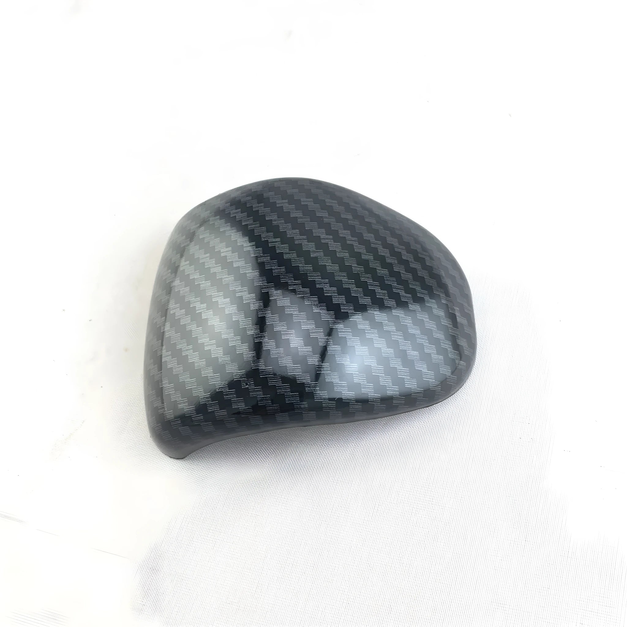 Black carbon fibre pattern gear shift cover for car interior with textured anti-slip surface