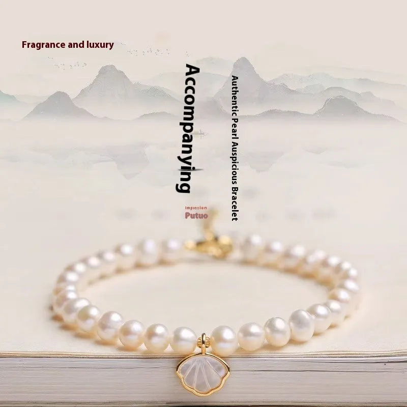 Women's freshwater pearl bracelet with fan-shaped alloy clasp, shown with both elastic and chain fastening options.