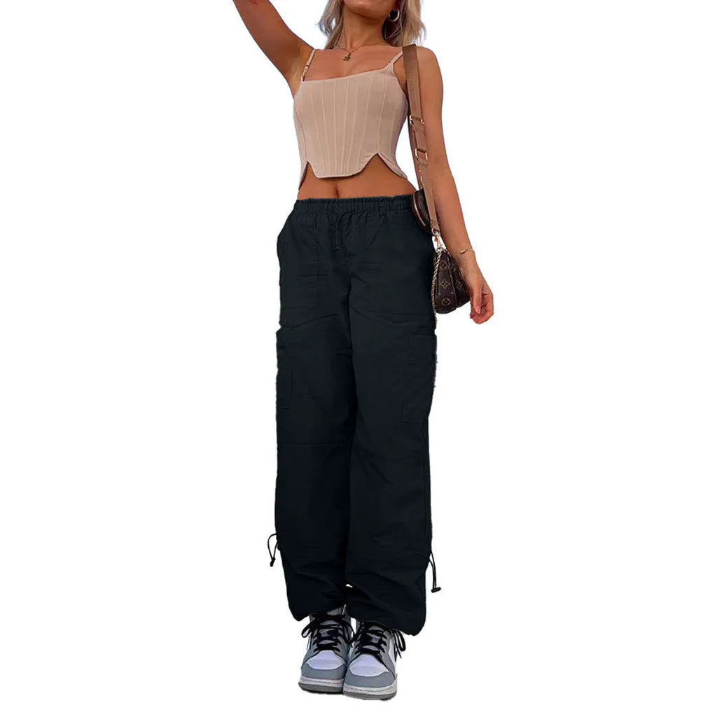 Man wearing loose grey straight-leg cargo casual pants with multiple pockets.
