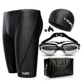 Men's black swimming set including briefs, anti-fog goggles, waterproof cap, ear plug nose clip, and carrying bag
