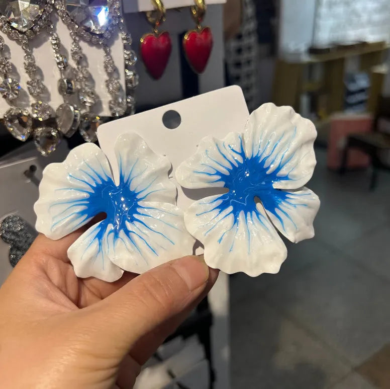 Close-up of pastoral style alloy flower stud earrings with oil-spot glaze in blue, green, purple, and rose colours