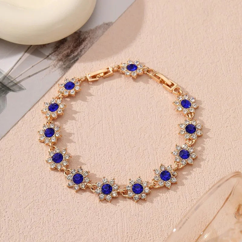 Floral zinc alloy bracelet with electroplated gold or silver finish and gemstone colour variants