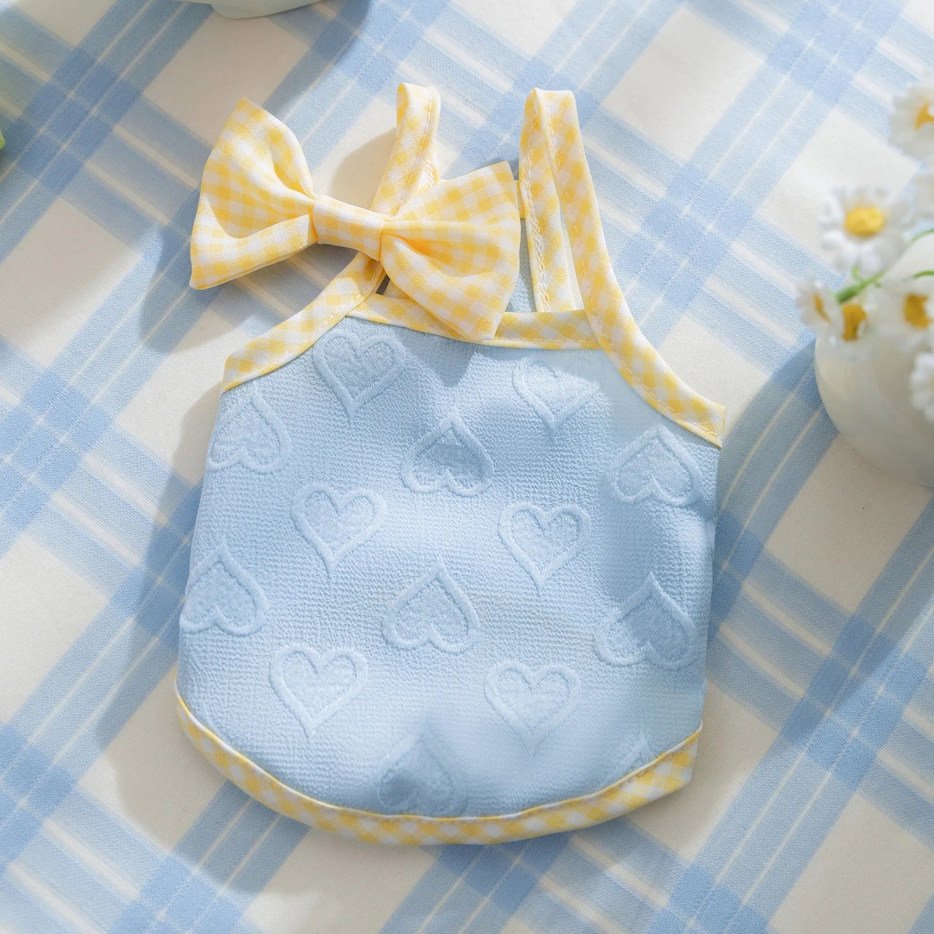 Small dog wearing heart texture vest with bow suspenders in Bondi Blue colour