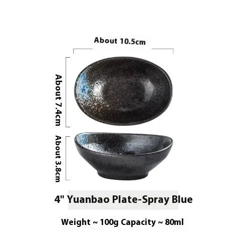 Oval Japanese ceramic sauce dipping bowl with underglaze finish on a table.