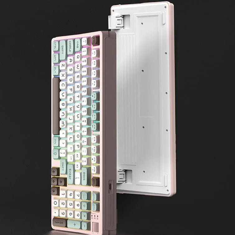 Luminous plastic computer keyboard in one of four colour combinations on a desktop.