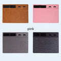 Pink PU leather wireless charging mouse pad with phone holder on a desk, showing USB cable.