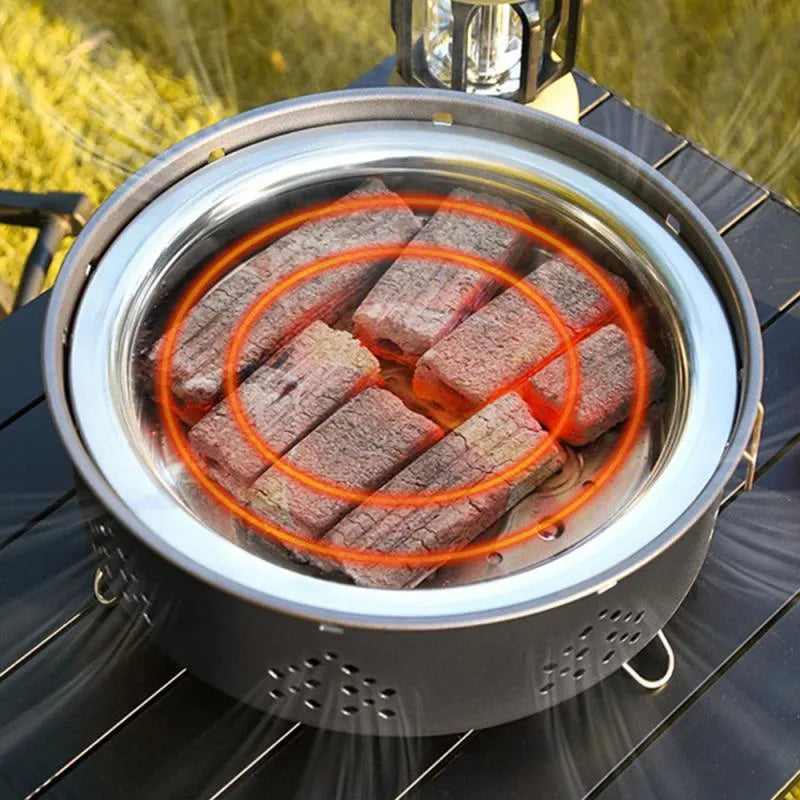 Portable stainless steel BBQ grill with detachable parts and storage bag, shown in grey colour.