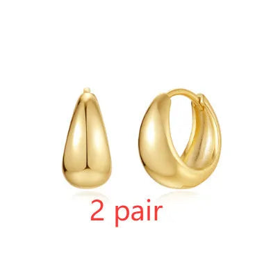 Geometric brass earclip earrings with round elements in golden and gold finishes