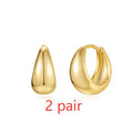 Geometric brass earclip earrings with round elements in golden and gold finishes