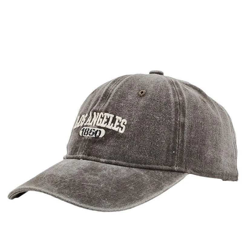 Retro personalised distressed embroidered peaked cap in beige colour with adjustable strap and conical crown.
