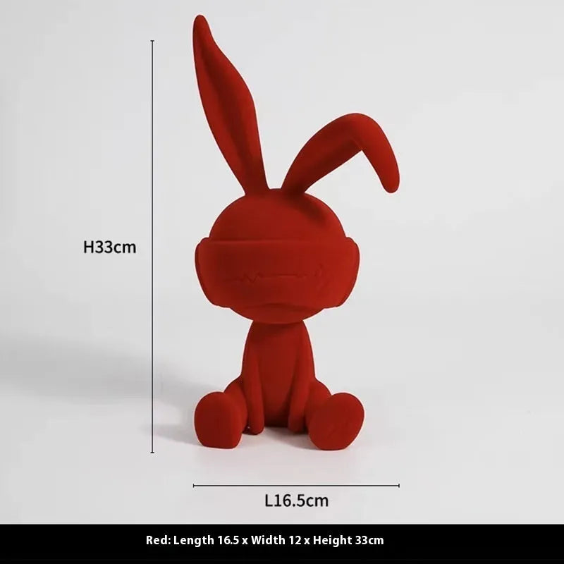 Suede blindfold rabbit resin table ornament in chosen colour on a wooden surface.