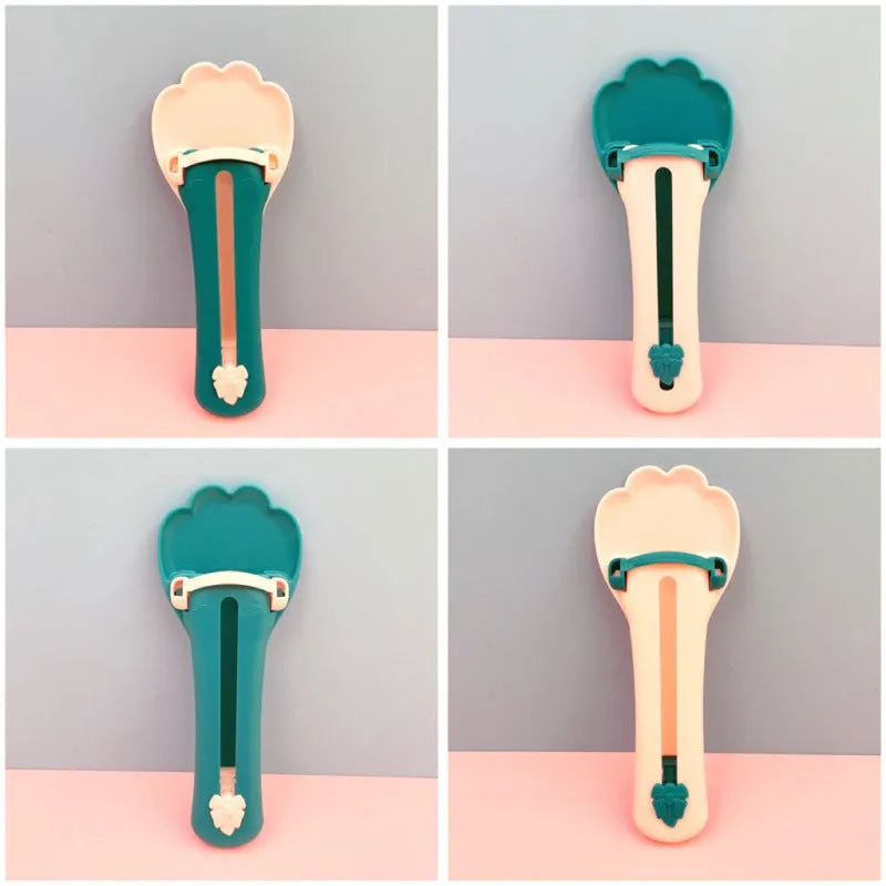 Green and pink pet food squeezer scoop dispensing a treat for a cat or dog.