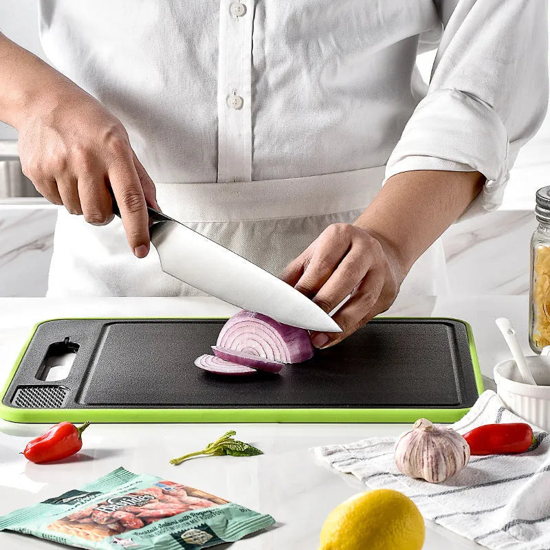 Grey square double-sided aluminium cutting board with hanging loop, defrosting surface, and built-in whetstone