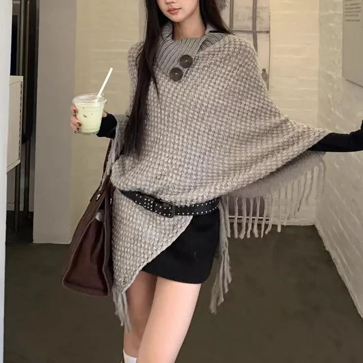 Women's triangular plush shawl cape in a cashmere blend with tassel detailing.