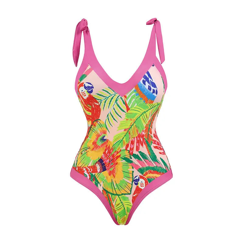 Pink floral print women's one-piece swimsuit with V-neck and matching skirt on beach