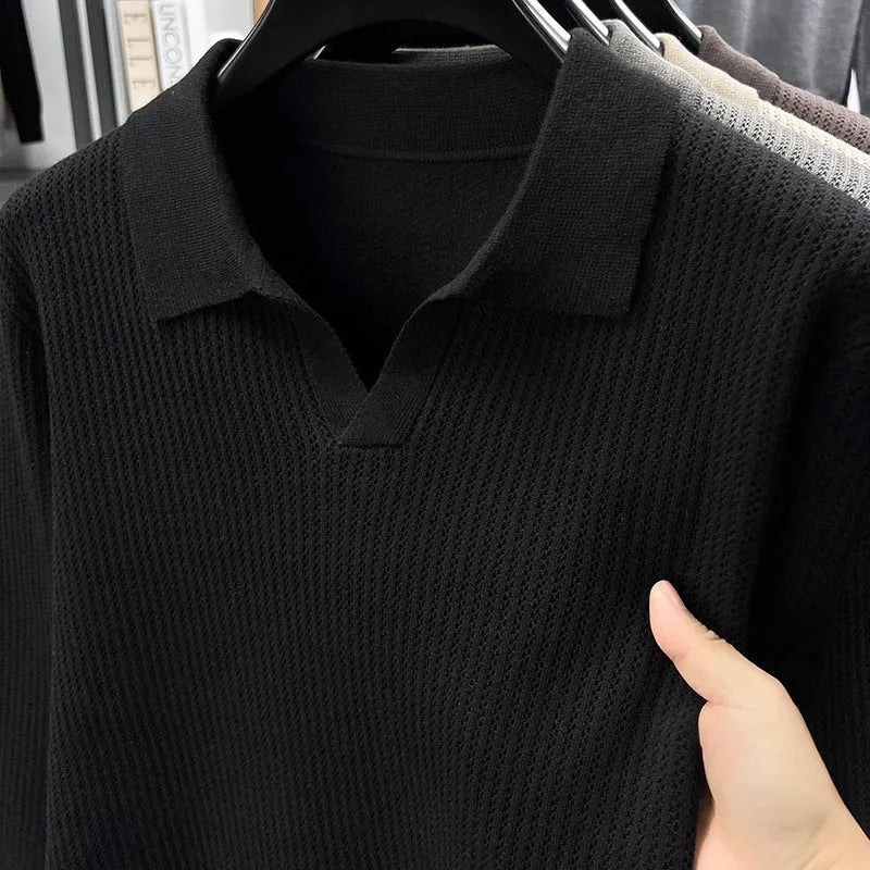 A man's loose-fitting casual pullover jumper in a neutral colour, shown on a model.