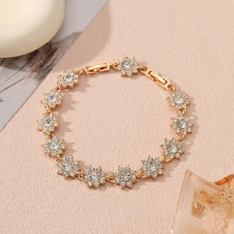 Floral zinc alloy bracelet with electroplated gold or silver finish and gemstone colour variants