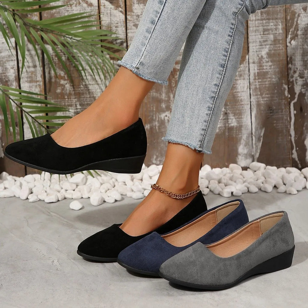 Women's pointed toe wedge pumps in suede with a low heel and shallow mouth opening.