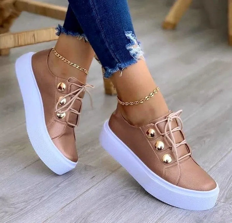 Women's white lace-up flats sneakers with metal rivet detailing and round toe design