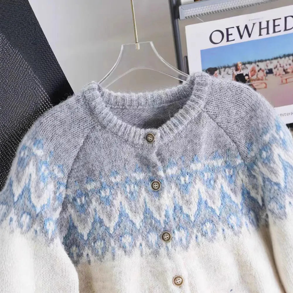 Women's beige jacquard knit sweater coat with contrast pattern, shown with long sleeves and a loose fit.