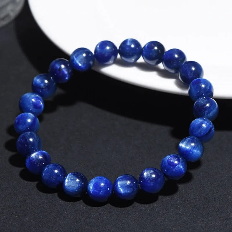 Natural blue crystal ball bracelet with geometric shape and Ruyi detail on a white background.