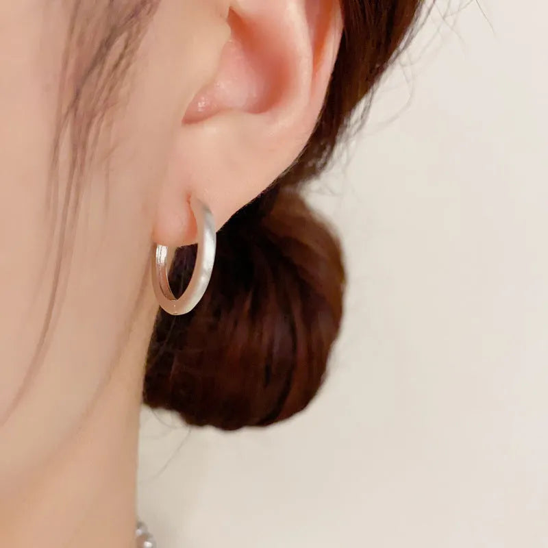 Women's geometric ear clip with round design in gold and silver plated finishes