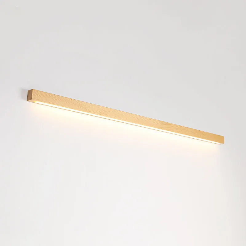 Walnut colour wood and acrylic wall lamp strip with LED lighting in a minimalist design on a wall.