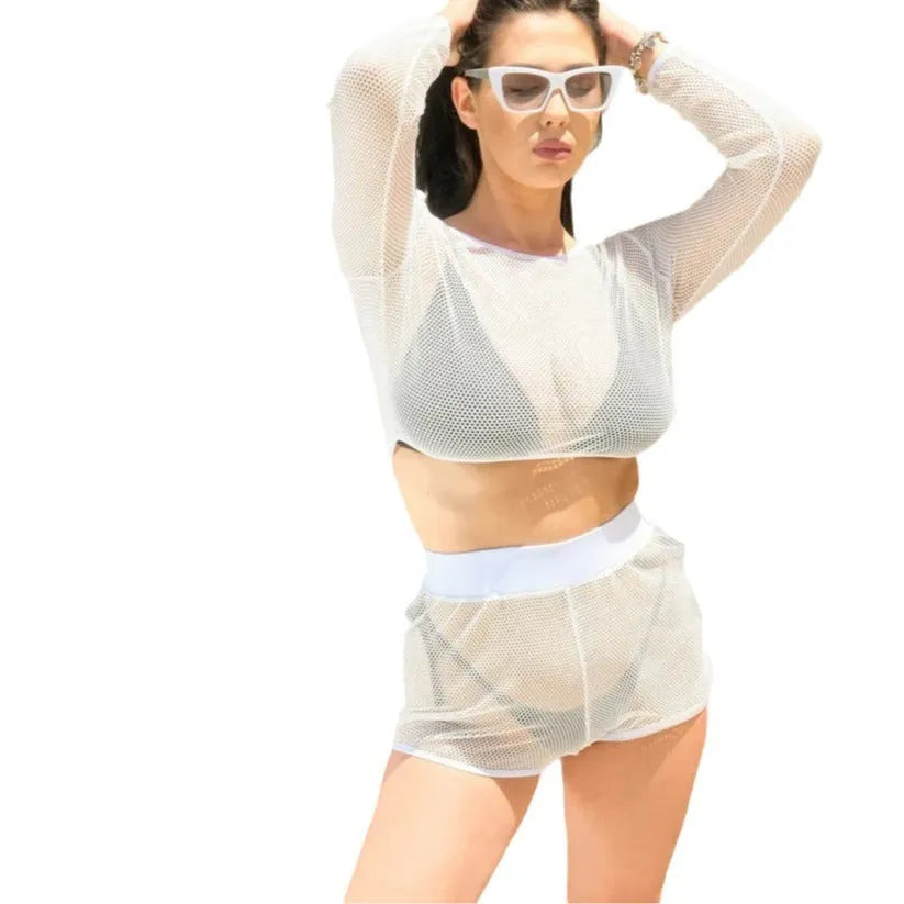 White transparent women's swimsuit with strap design and matching skirt on a beach background