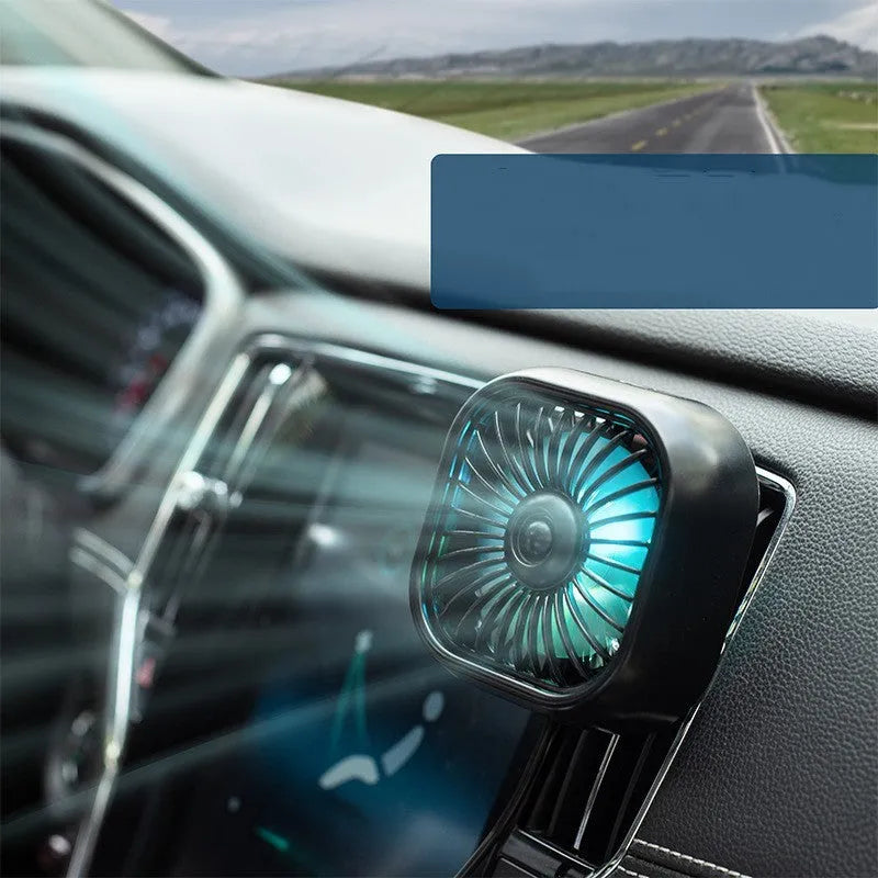 Small black USB fan with keyboard controls for three speed settings on car dashboard