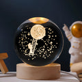 Illuminated starry sky crystal ball on a wooden base, with USB cable for power.