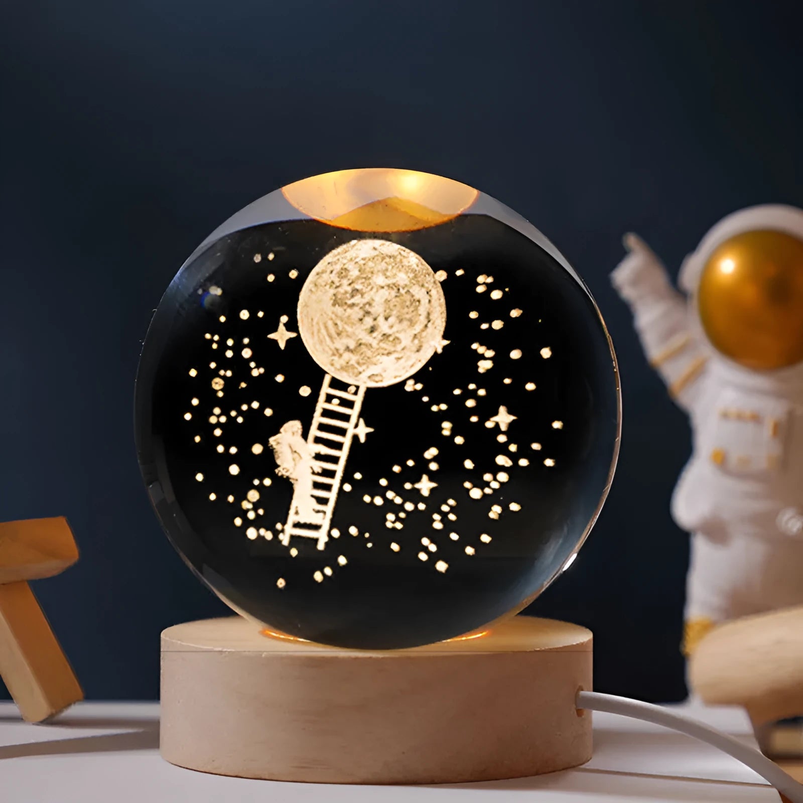 Illuminated starry sky crystal ball on a wooden base, with USB cable for power.