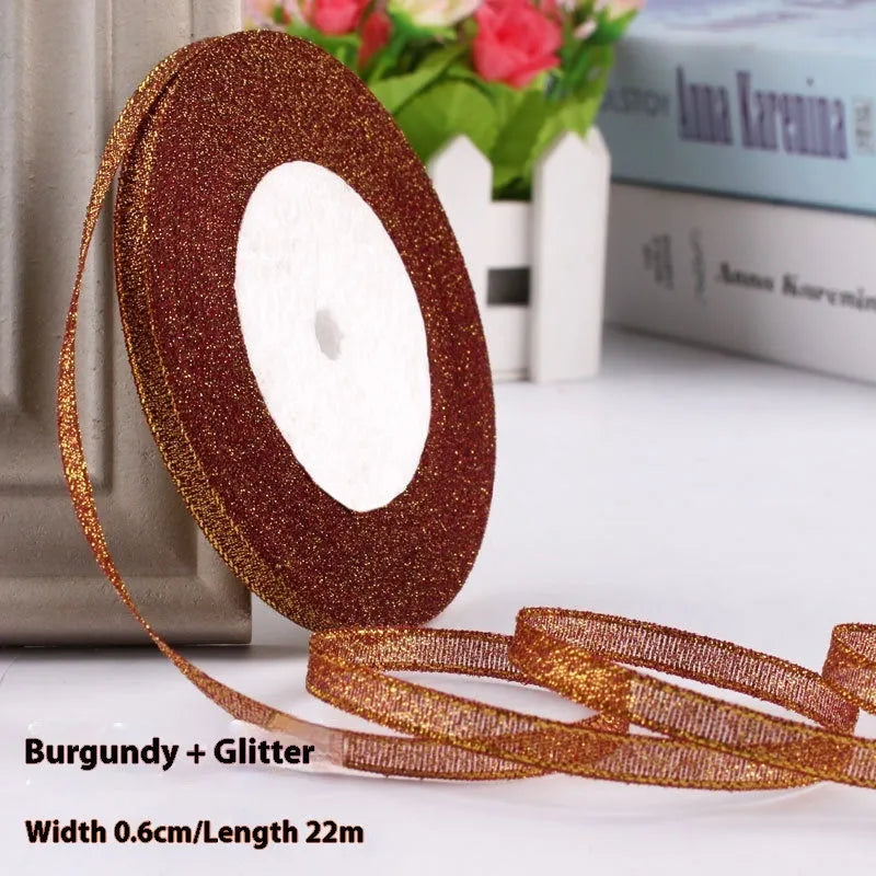 Roll of 0.6cm wide polyester gift ribbon in various colours including gold leaf, coffee and sky blue options