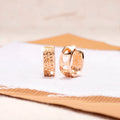 Rose gold hollow heart earrings with circular design and electroplated finish