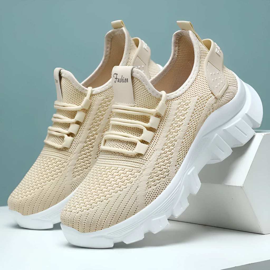 Women's white Flyknit running sneaker with thick PVC sole and lace-up front on a neutral background.