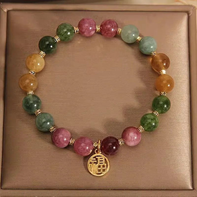 Electroplated tourmaline bracelet with flower and fu character pendant designs in natural colours