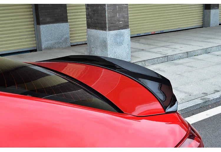 Bright black Mazda 3 Axela Exela tail trim for 2014-2021 models showing large fixed wind surrounded blade design