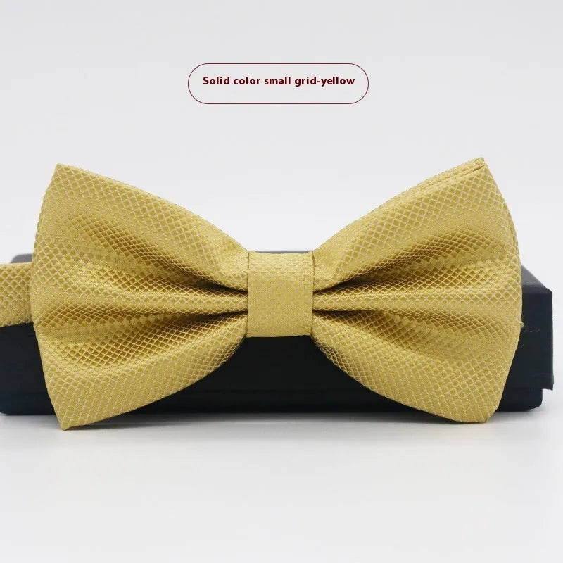 Men's flat head style polyester bow tie in a solid colour, shown with adjustable neck strap.