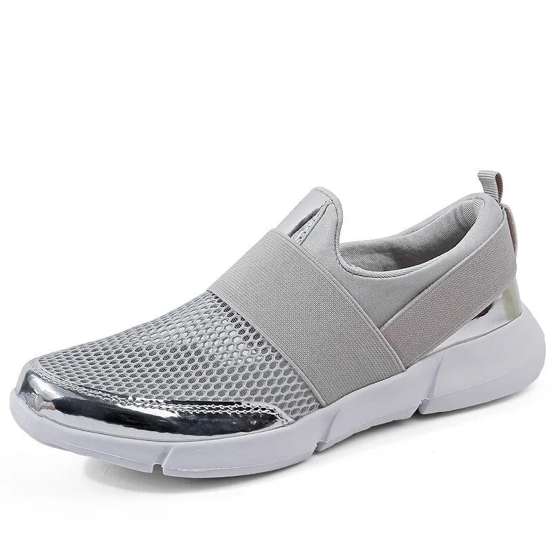 Low-cut blue women's casual sneakers with mesh upper on a hard floor surface.