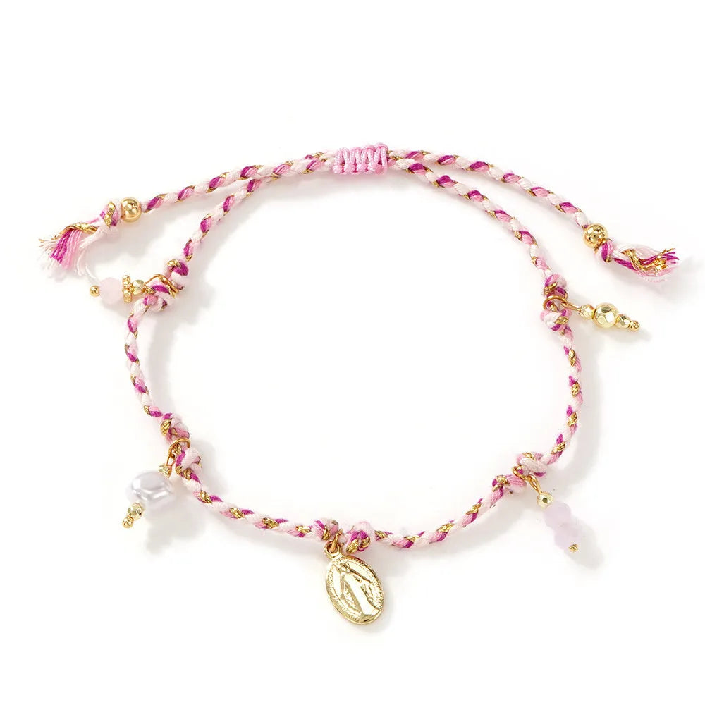 Close-up of a hand-woven colourful braided rope bracelet with an adjustable strap tag, showing ethnic style design.
