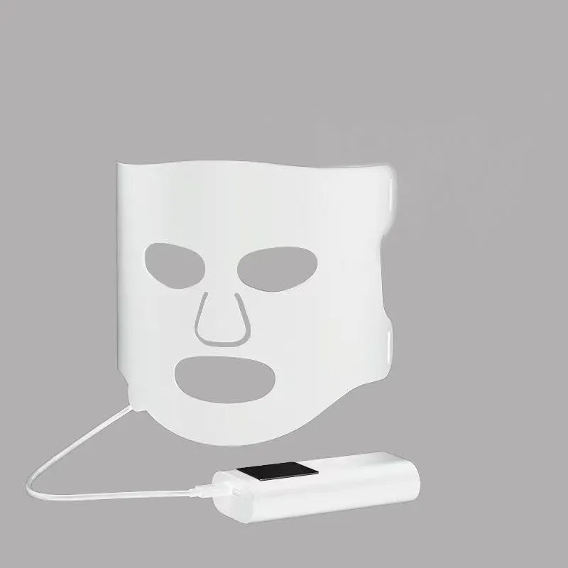 Black and gold LED phototherapy face mask with controller, shown with its USB charging cable.