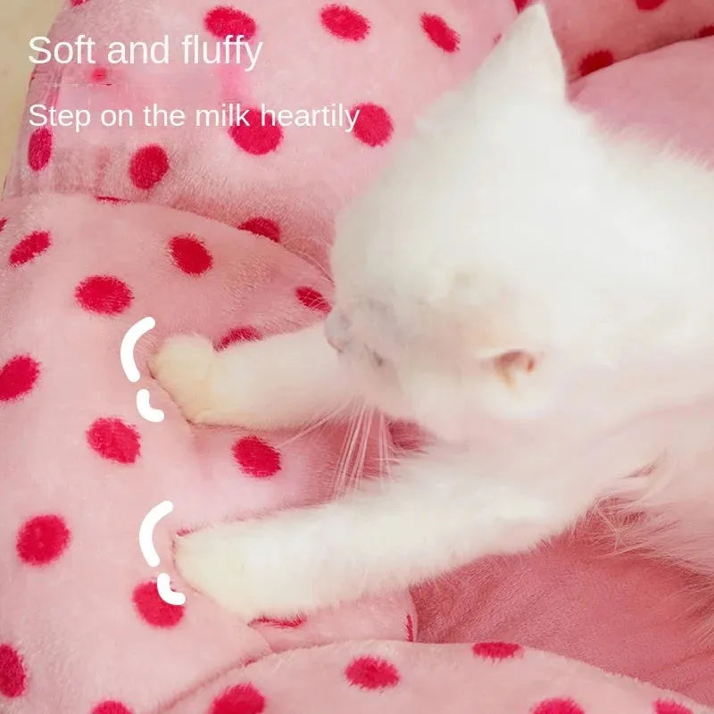 Round pink cat bed with dot pattern and cushion for indoor sleeping