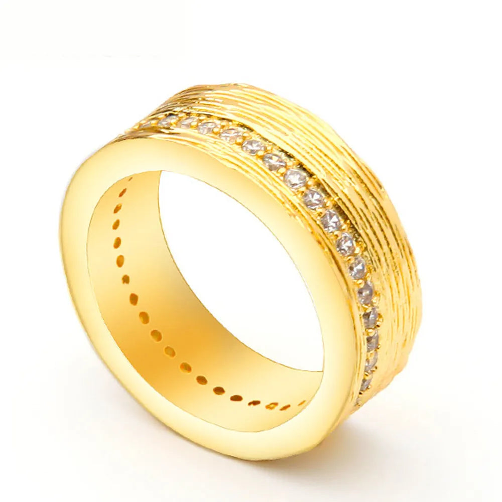 Gold colour geometric women's ring with a zircon stone on a copper band.