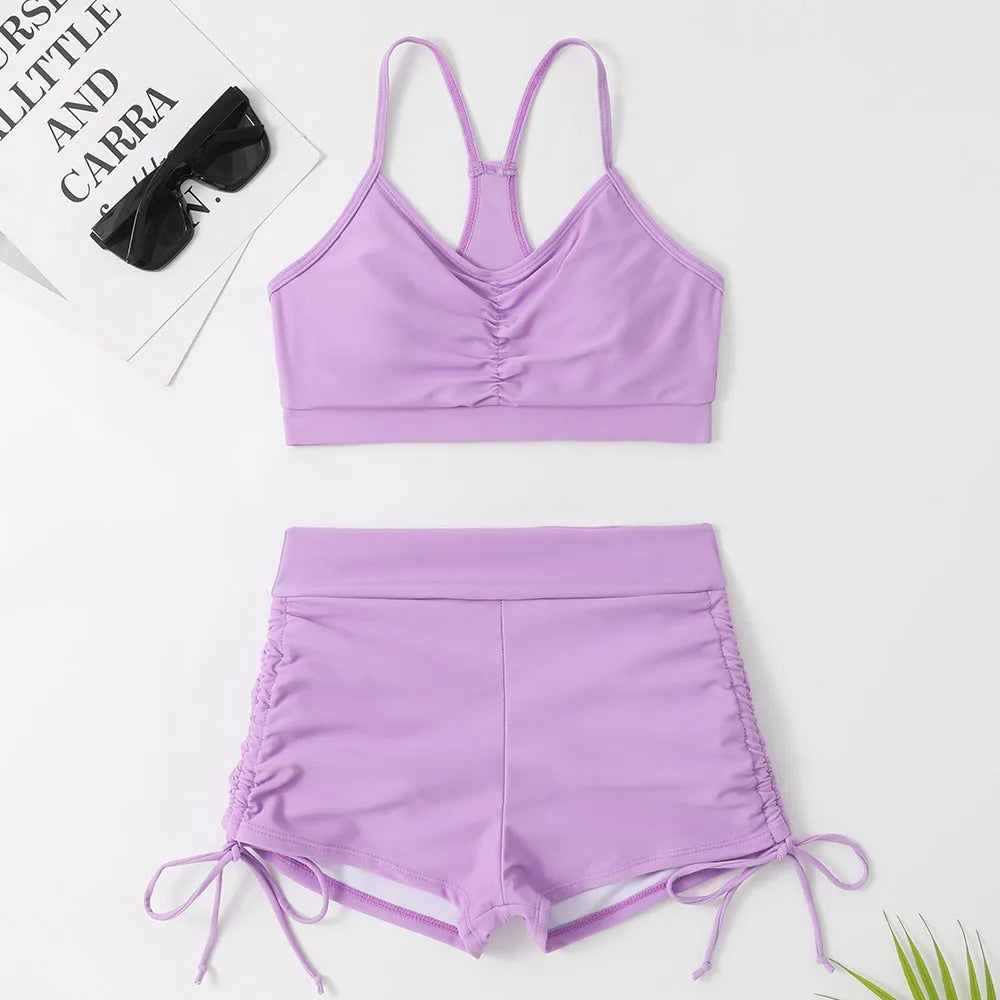Women's violet high-waist split bikini swimsuit on a mannequin, showing top and shorts.