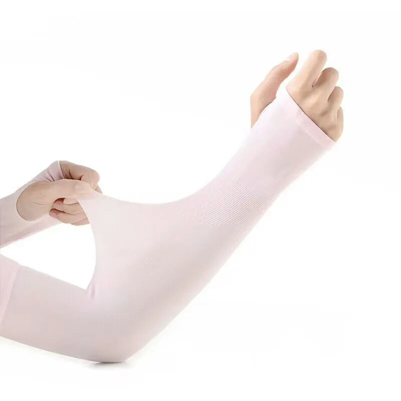 A person wearing a grey sun protection driving sleeve on their forearm, showing the open finger design.