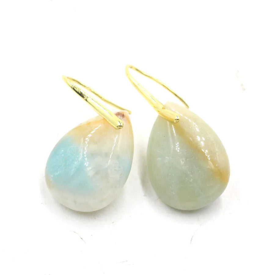 A pair of geometric water drop earrings made from crystal, shown in one of nine available colours like amethyst or obsidian.
